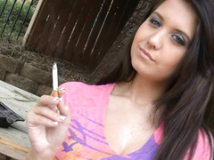 Brunette cutie Chrissy Marie looks hot while smoking a cigarette