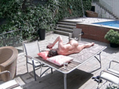 Fiora is sunbathing on the pool terrace