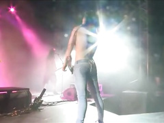 Amateur girl dances and strips on concert stage