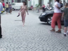 young woman with big breasts walks naked among the peop