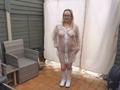 Naked wearing Plastic Transparent Raincoat and White PVC Boots in the freezing Cold outdoors