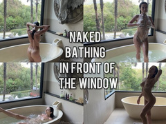Naked bathing in front of a big window