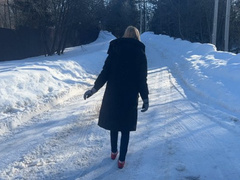 girl in ballet shoes walks along an icy road and slips a lot