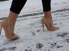 Girl on Louboutin high heels pumps walking on very slippery ice, in louboutin walking on ice
