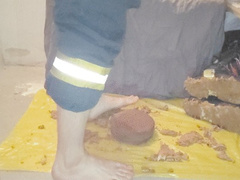Firefighter stomping a Cake