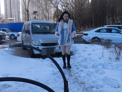 Chinese girl tickles outdoors in winter when it's too cold
