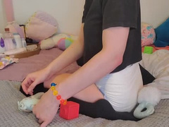 Wet Diaper Girl Plays With Toys