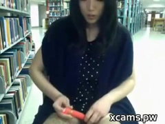 cute chinese girl uses vibrator in public library
